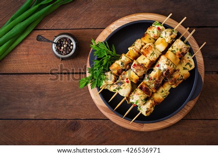 Chicken skewers with slices of apples and chili. Top view
