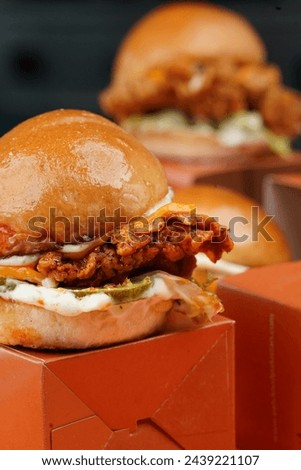 Chicken slider with another slider in the background.