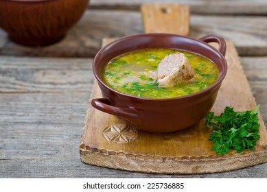 chicken soup with the stuffed chicken neck in a ceramic bowl. Jewish cuisine. selective focus