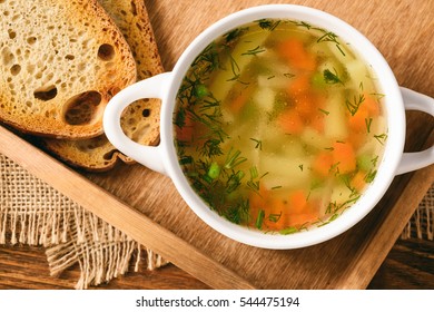 Chicken Soup In White Bowl On Wooden Tray.