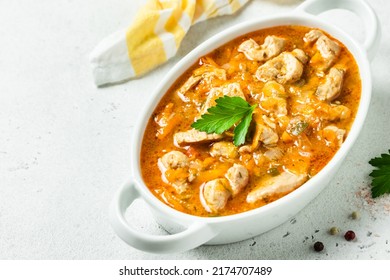 Chicken spicy goulash in pot. Top view, copy space.