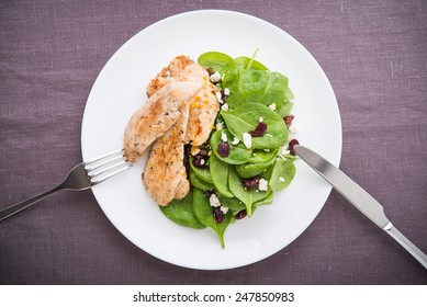 Chicken With Spinach Salad On Dark Background Top View. Healthy Food.