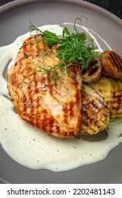 Chicken Steak With Vegetables In A Ceramic Plate On A Dark Textured Background. Restaurant Menu Isolated On Black