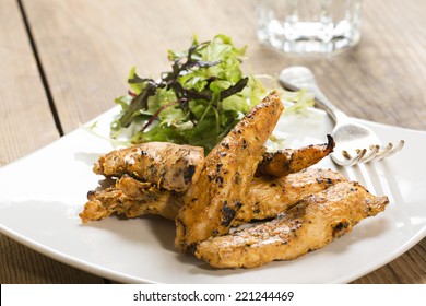 Chicken Strips, On A White Square Plate With A Side Salad