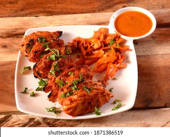 Chicken Tandoori Momo Served With Sauce Over A Rustic Wooden Background, Selective Focus