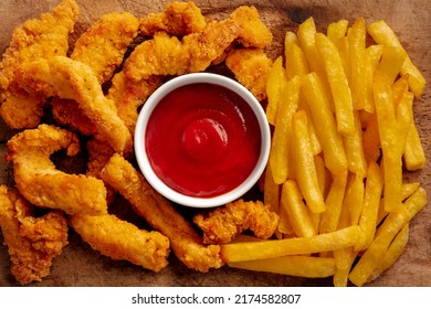 Chicken Tenders, Breaded And Fried, With A Barbecue Sauce And French Fries, Shot From Above