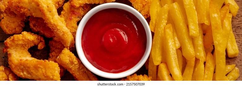 Chicken Tenders Panorama, Crispy Boneless Meat Pieces With A Red Dip And French Fries, Overhead Shot