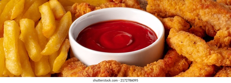 Chicken Tenders Panorama, Crispy Boneless Meat Pieces With A Red Dip And French Fries