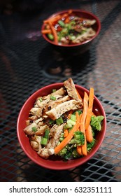 Chicken Teriyaki Bowls With Brocolli Carrot And Brown Rice On Table Looking From Top View