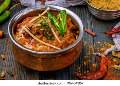 chicken tikka masala Indian food on wooden background with spices 