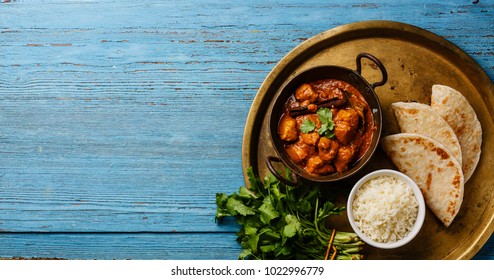 Chicken tikka masala spicy curry meat food Butter chicken with rice and naan bread on blue wooden background copy space