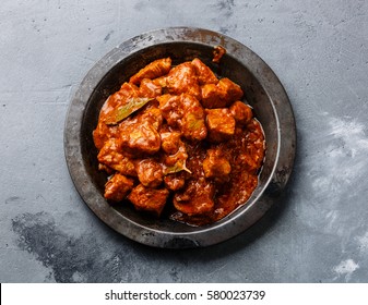 Chicken tikka masala spicy curry meat food in metal plate close-up