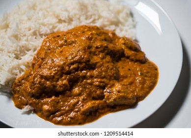 A Chicken Tikka Massala Curry On A White Plate