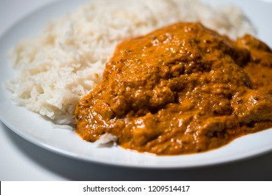 A Chicken Tikka Massala Curry On A White Plate