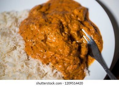 A Chicken Tikka Massala Curry On A White Plate