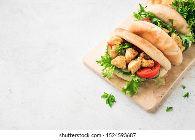 Chicken Tikka Naan Sandwich. Indian Flatbread sandwich with chicken and vegetables, copy space.