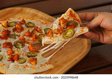 chicken tikka pizza, spiced chicken cubes and mozzarella cheese combination
