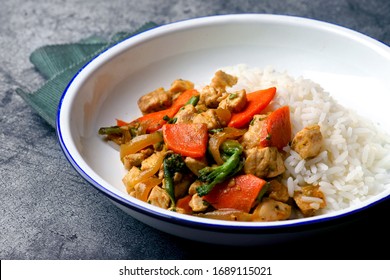 Chicken And Vegetable Sauté With Rice On A White Plate