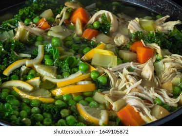 Chicken And Vegetable Stew In A Cast Iron Pot On The Stove.