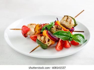 Chicken and vegetables kebabs or skewers in a plate