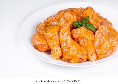 Chicken Wing In A Honey Mustard Marinade On A White Background Close-up. Raw Chicken Prime  Wings. 