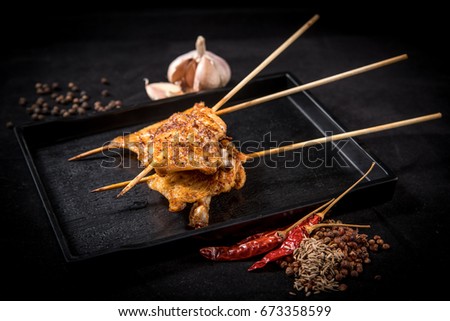 chicken wing mala grilled on table with blackground (selective focusing)