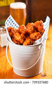 Chicken wings bucket with beer in restaurant 