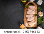 Chicken wings cooking background with raw uncooked chicken wings, condiments and spices. BBq, grilling poultry meat preparation background copy space top  view