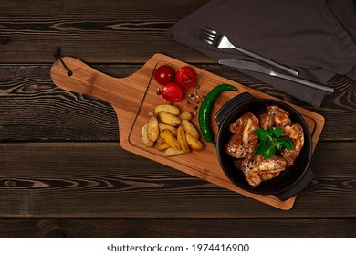 Chicken Wings, Fried, Barbecue, With Potatoes, On A Chopping Board, Cherry And Pepper, Wooden Table, Top View, No People,