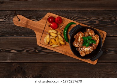 Chicken Wings, Fried, Barbecue, With Potatoes, On A Chopping Board, Cherry And Pepper, Wooden Table, Top View, No People,