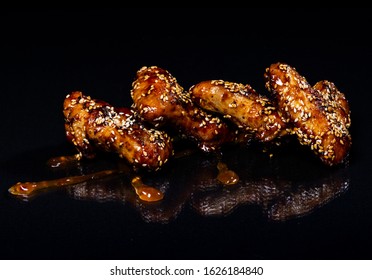 Chicken Wings With Honey On A Black Background.