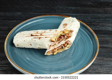 Chicken Wrap. Meat Wrap. Dark Wooden Background. Top View. On A Blue Plate. Shaurma