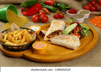 Chicken wrap sandwich with french fries, vegetable and sauce