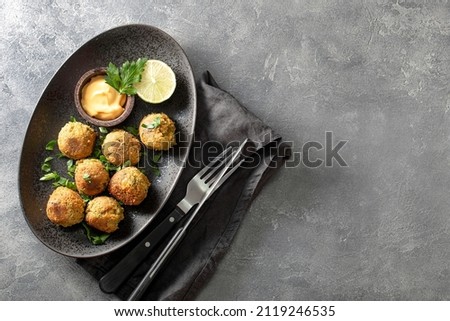 Chickpea falafel with sauce on black plate and grey background top view, copy space for text Stock photo © 