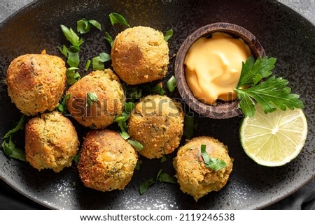 Chickpea falafel with sauce on black plate close up top view Stock photo © 