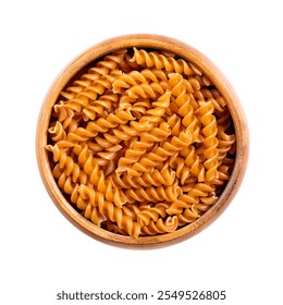 Chickpea spiral pasta, gluten free noodles in a wooden bowl, isolated from above. Small fusilli, a pasta variety with helical or corkscrew shape, made of chickpea flour, an alternative to wheat flour. - Powered by Shutterstock