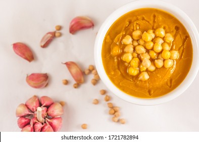  Chickpeas Soup In A Bowl And Purpple Garlic. Chick Pea Soup. Copy Space. Top View