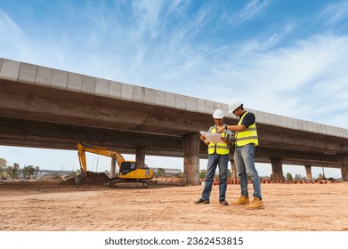 The chief civil engineer is introducing inspection of a road or expressway construction project under the road to an intern. At the expressway construction site