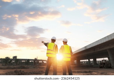 The chief civil engineer is introducing inspection of a road or expressway construction project under the road to an intern. At the expressway construction site - Shutterstock ID 2362454125