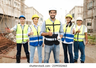 Chief Engineer And Foreman Team Celebrate Residential Project Development Success With Smile At Construction Site. Group Of Successful Construction Workers Enjoy Working, And Bonding With Teamwork.