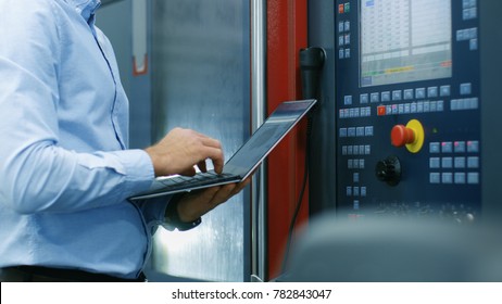 Chief Engineer/ Operator Programs/ Sets-up CNC Machine with Control Panel. He Works on the Modern Technologically Advanced Factory. - Powered by Shutterstock