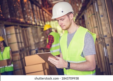 Chief Engineer Using Ipad At The Warehouse Store After The Factory Reopening From The Covid-19 Pandemic