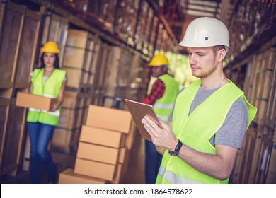 Chief Engineer Using Ipad At The Warehouse Store After The Factory Reopening From The Covid-19 Pandemic