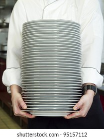 Chief Holding A Stack Of Plates