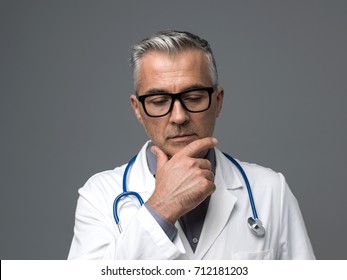 Chief Physician Thinking With Hand On Chin: Medical Advice, Diagnosis And Healthcare Professionals Concept