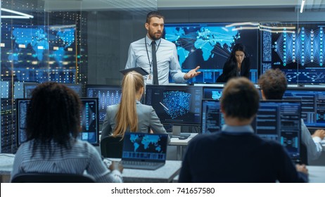 Chief Project Engineer Holds Briefing for a Team of Scientists that are Building Machine Learning System. Displays Show Working Model of Neural Network. - Powered by Shutterstock