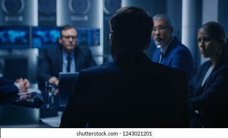 Chief Strategy Officer Making Report To A Board Of Directors During Annual Financial Meeting In The Conference Room. Business People / Politicians / Government Officials On A Meeting.