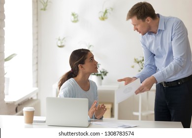 Chief And Subordinate Talking At Workplace, Dissatisfied Boss Points On Rude Mistakes On Report Criticizing Work Scolding Accusing Young Female Employee. Frustrated Woman Office Worker Making Excuses