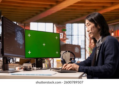 Chief technical officer uses mockup PC in AI tech agency providing software development services. Startup IT specialist uses artificial intelligence to streamline coding process on green screen PC