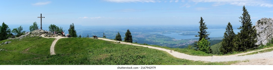 Chiemgau Alps, Upper Bavaria,  Germany, June 5, 2022, panoramic view with KAB mountain cross Kampenwand on the foothills of the Alps with Lake Chiemsee

